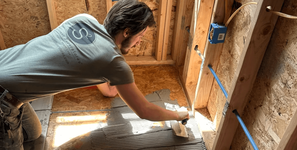 noah-working - The Remodel Co. Noah Paton grouting floor to install tile