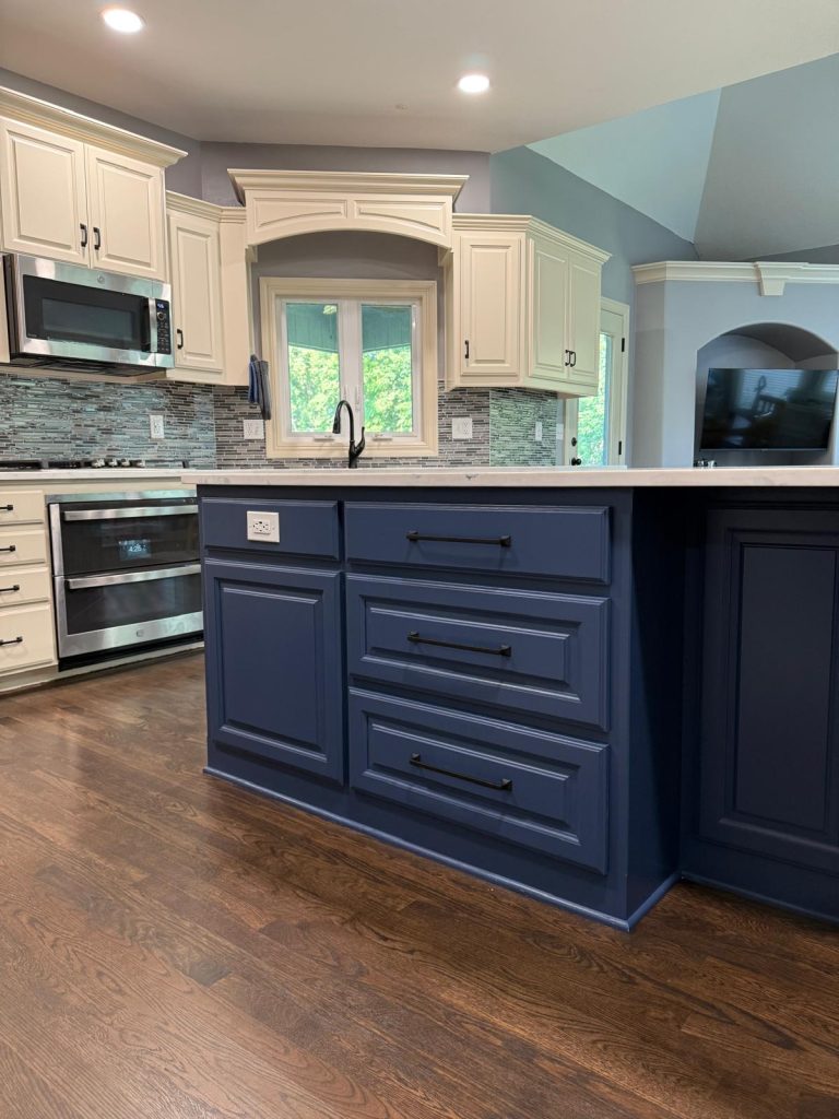 Luxury modern kitchen remodel with custom island, premium tile backsplash, and white cabinetry — Kansas City homeowner project by The Remodel Co